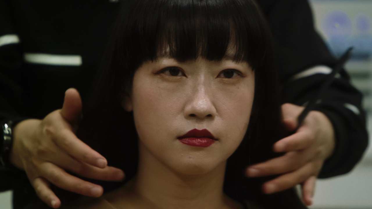 a woman with lipstick getting her hair styled